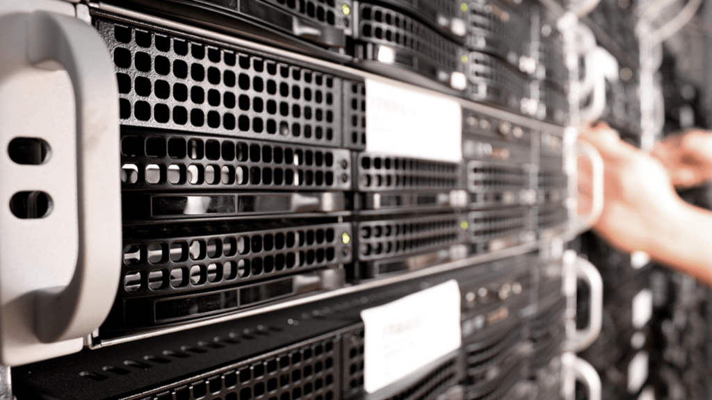 a person working on a server rack in a data center