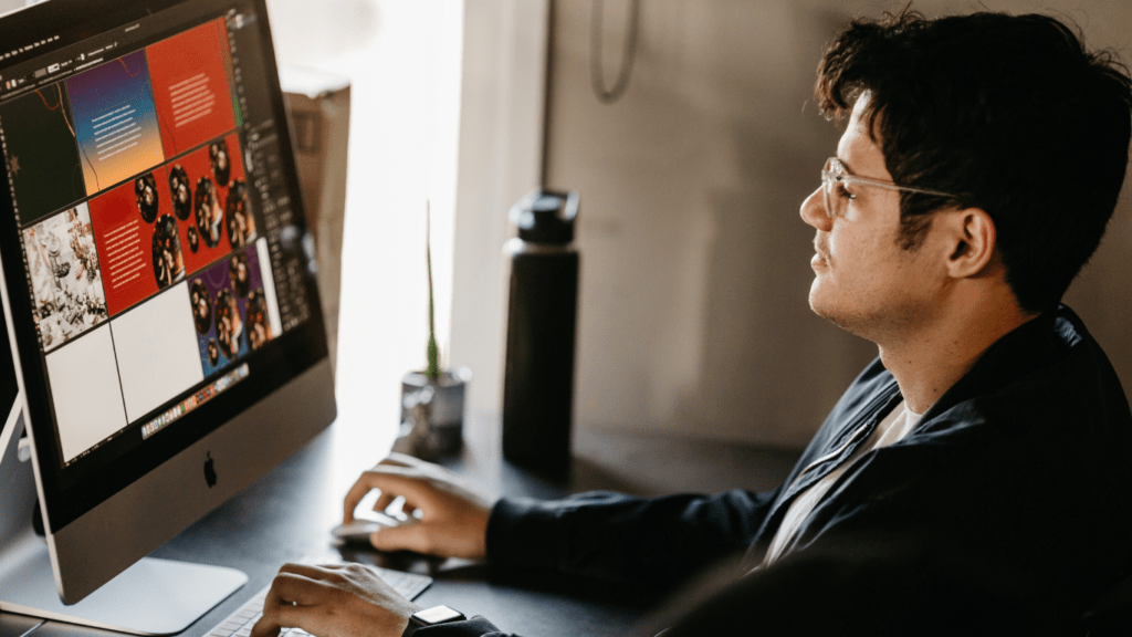 a person sitting at a desk in front of a computer screen