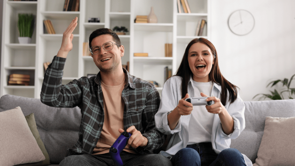 Two people sitting on a couch playing video games