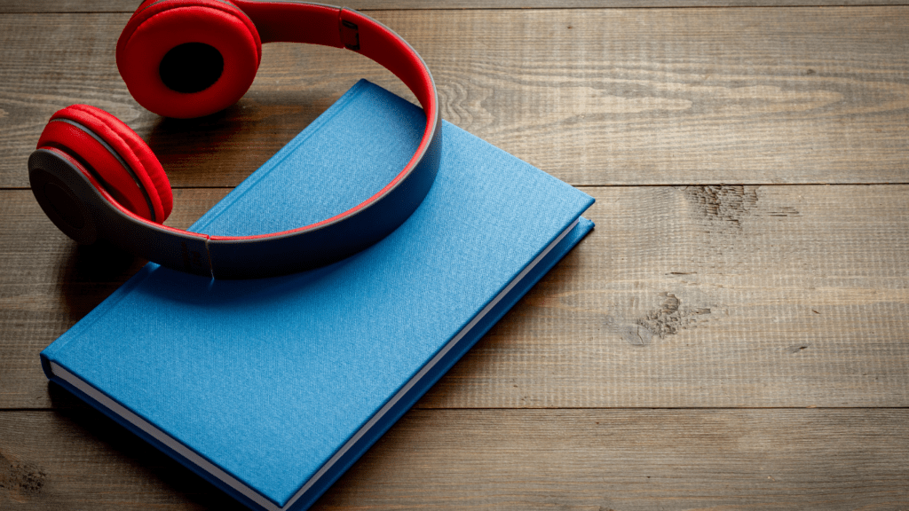 Headphone and book on a wooden surface