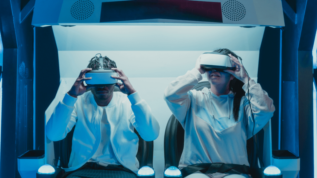 Two people wearing virtual reality glasses at a desk