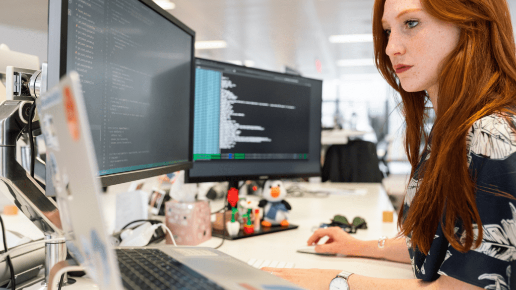 a person sitting at a desk in front of a computer