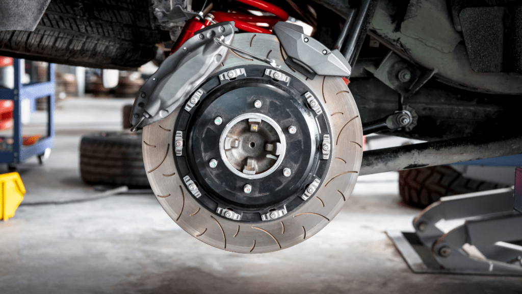 a person is working on the brakes of a car