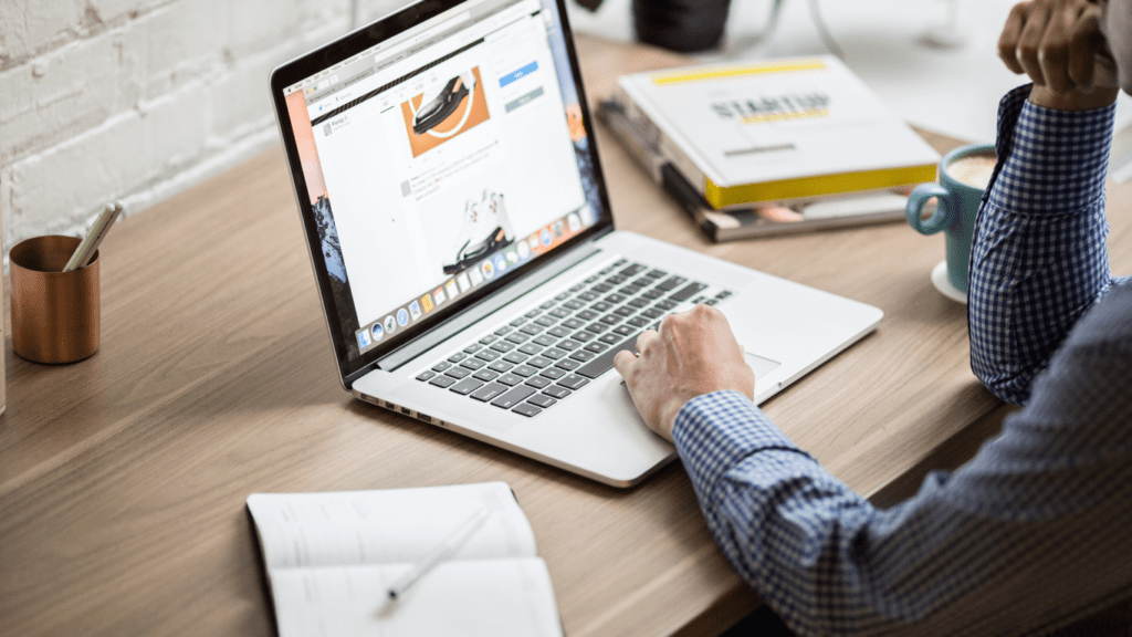 a person sits at a desk with a laptop