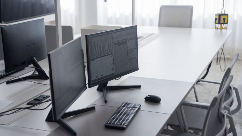 a row of computer monitors in a classroom