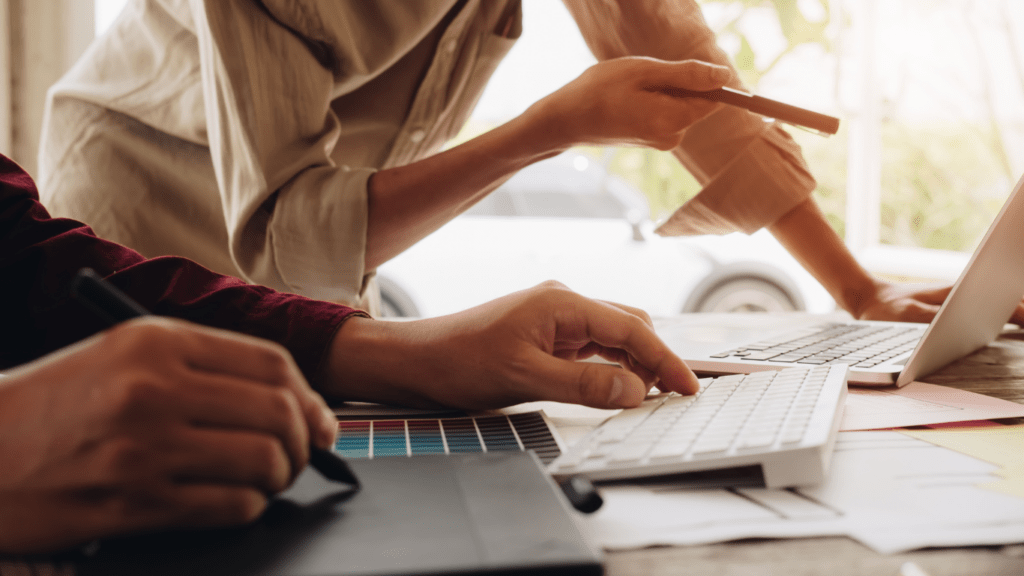 two business people working on a laptop and tablet