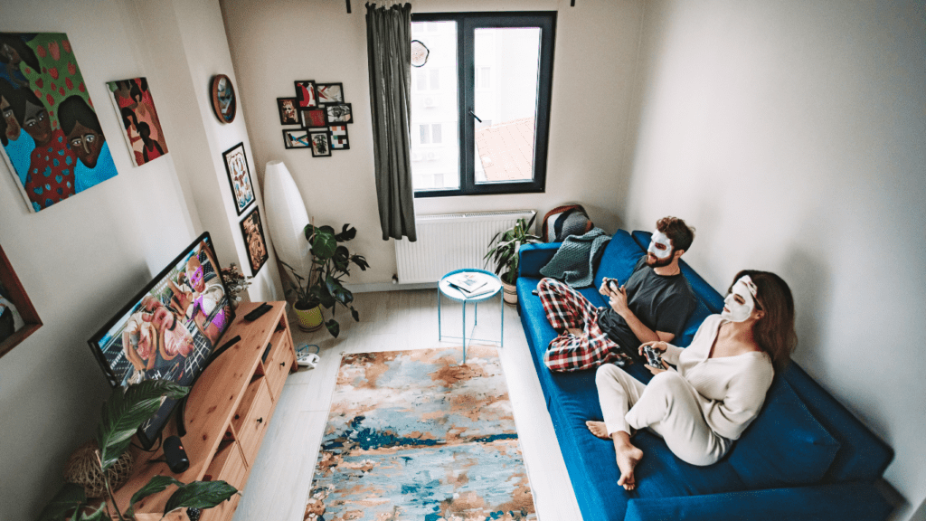 two people holding video game controllers in front of a television