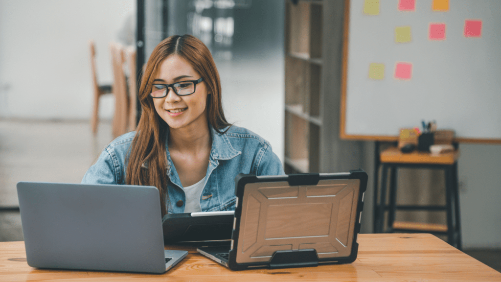 two people working on their laptops in front of each other